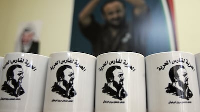 Mugs bearing Barghouti's image and the slogan, in Arabic, 'Freedom for the knight of freedom', on display at an office campaigning for his release in the West Bank city of Ramallah in February 2009. AFP
