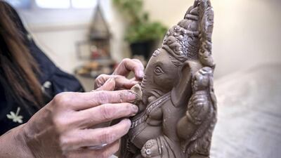 Savvy Kisani hand sculpts clay Ganesh idols at her home in Dubai. Antonie Robertson / The National