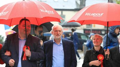 Labour Party leader Jeremy Corbyn, center, arrives Friday May 3, 2019 to celebrate the election result for Trafford Council with Labour Party activists at the Waterside Arts Centre, Manchester, England, following the voting in Thursday's English council elections. (Peter Byrne/PA via AP)