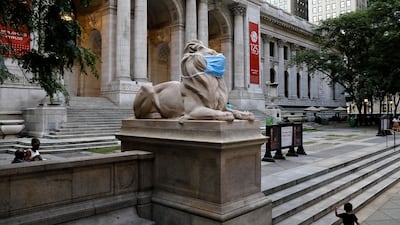The lion statue in front of the 42nd street New York Public Library adorns a protective mask to remind the public to wear masks. EPA