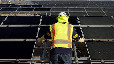 A worker installs photovoltaic solar panels at the Agua Caliente solar project in Yuma County, Arizona in 2012. The same panels will be installed at the Mohammed bin Rashid Al Maktoum solar park in Dubai. Joshua Lott / Bloomberg News