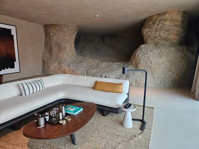 Our living room with a statement rock wall. Photo: Katy Gillett for The National
