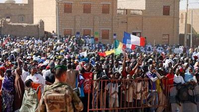 People gather to greet French President Francois Hollande during his two-hour visit to Timbuktu on Saturday. Benoit Tessier / Reuters