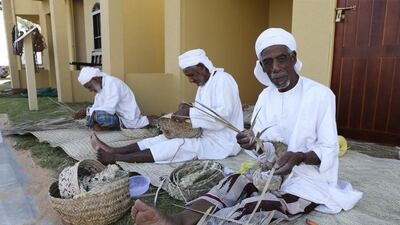 Men make traditional woven handicrafts at the Sheikh Zayed Heritage Festival. Sarah Dea / The National