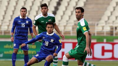 Thailand's Chanathip Songkrasin (18) passes the ball past Iraq's Saad Abdul-Amir, right, during a qualifying match in March. Atta Kenare / AFP