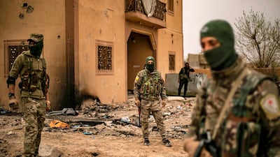 Members of the US-backed Syrian Democratic Forces walk in the village of Baghouz in Syria's eastern Deir Ezzor province near the Iraqi border a day after the ISIS "caliphate" was declared defeated. AFP