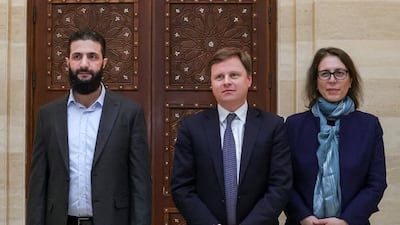 Mr Al Shara with Stephen Hickey, centre, director of the Middle East and North Africa department at Britain's Foreign Office, and Ann Snow, UK special representative for Syria. AFP