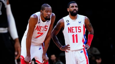 Brooklyn Nets' Kevin Durant, left, talks to Kyrie Irving during the game against the San Antonio Spurs. AP