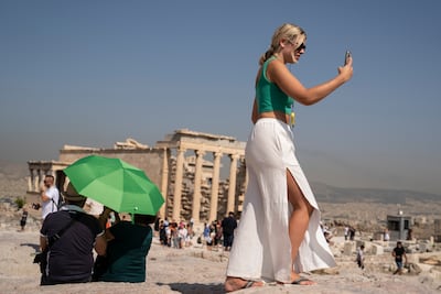 A tourist in Athens, Greece, where the government has announced emergency measures to cope with the heat. AP