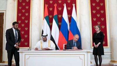 Sheikh Mohammed bin Zayed, Crown Prince of Abu Dhabi and Deputy Supreme Commander of the UAE Armed Forces (second left) and Vladimir Putin, President of Russia (second right) sign a memorandum of understanding, at the Kremlin Palace. Mohamed Al Hammadi / Crown Prince Court - Abu Dhabi