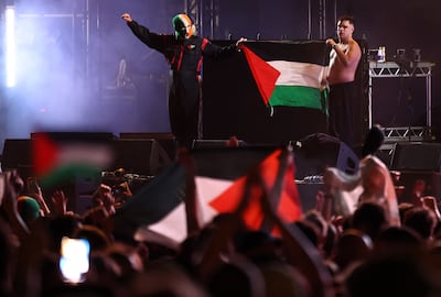 Naoise O Caireallain, right, and JJ O Dochartaigh of Kneecap hold up an Palestine flag during the Wide Awake Festival in south London on Friday. AFP