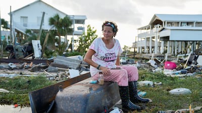 Jewell Baguette, 51, amid the wreckage of the home built by her grandfather, where she grew up. Three generations of her family have lived in the house. Reuters
