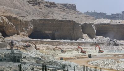 Bulldozers demolish a Mokatam hill to expand the road, as part of a mega project campaign for roads and bridges, in Cairo, Egypt, 14 June 202 EPA / KHALED ELFIQI