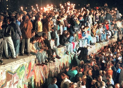 Young residents of East Berlin celebrating on top of the Berlin Wall after communism in Eastern Europe began to implode in 1989. AFP