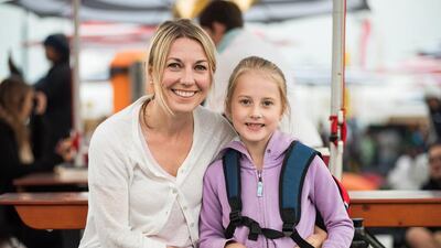 Tilly Thompson, seven, waits for her father to complete the race with her mother, Tracey.