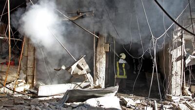 TOPSHOT - Smoke billows from a building following a reported bombardment by pro-Syrian government forces in the town of Maaret al-Numan in Syria's Idlib province, the country's last major opposition bastion. AFP