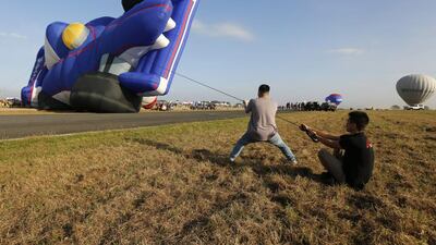 Balloonists prepare their hot air balloon at the former US Air Force base at Clark, Angeles City, Philippines. Francis R Malasig / EPA