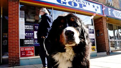 Larry the Conservative Dog and his owner, investment advisor Tom Bode, are seen outside the Racine County Republican Party Office in Racine, Wisconsin. Reuters