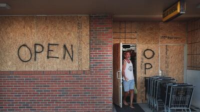 Shoppers grab supplies at a boarded-up strip mall in preparation for Hurricane Dorian on August 31, 2019 in Indialantic, Florida. Dorian, once expected to make landfall near Indialantic as a category 4 storm, is currently expected to turn north and stay off of the Florida coast, lessening the impact on the area. Scott Olson/Getty Images/AFP