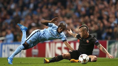 Manchester City's Fernandinho, left, challenges AS Roma's Radja Nainggolan during their Champions League match on Tuesday in Manchester. Andrew Yates / Reuters