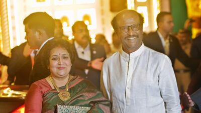 Indian superstar Rajinikanth and his wife Latha Rajinikanth arrive. AP Photo