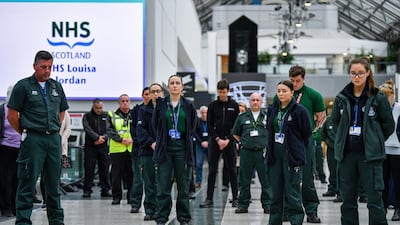 Medical staff at Louisa Jordan Hospital stand during a UK-wide moment of silence to commemorate workers who have died from coronavirus in April in Glasgow. Getty Images