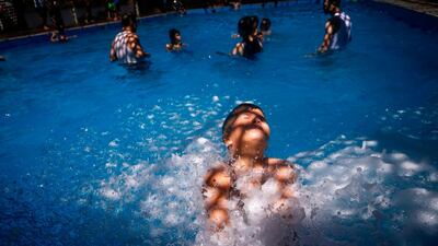 Palestinian youths play in a pool in Gaza city. AFP