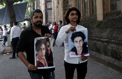 Fans of Bollywood actor Shah Rukh Khan hold posters calling for the release of his son Aryan Khan outside Bombay High Court in Mumbai, India. AP Photo