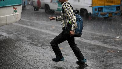 A man runs through heavy rain in Kolkata, India. A tropical depression continued during Cyclone Asani and heavy rainfall hit West Bengal and Andhra Pradesh. EPA
