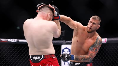 Mick Parkin, left, on his way to victory against Lukasz Brzeski in their heavyweight contest. PA