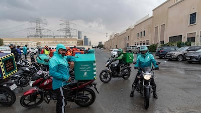 Delivery riders park up as rain falls in Dubai this week. Police urged drivers to be cautious in wet conditions. Antonie Robertson / The National