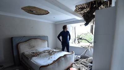Sven Good, 23, looks at the damage caused to his bedroom at his family home in Stondon Massey, near Brentwood, Essex, after a 400-year-old oak tree in the garden was uprooted by Storm Eunice. PA