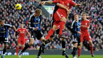 Liverpool’s Martin Skrtel heads the ball toward Stoke’s goal.