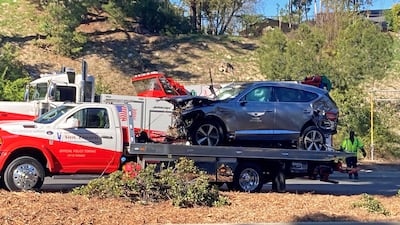 Tiger Woods' car is towed away in Los Angeles in April after the crash that smashed his leg. Getty