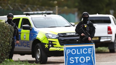 An armed police officer stands guard on a road near the perimeter of RAF Fairford. Reuters