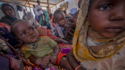 Sudanese refugees sit in a makeshift tent in the Adre transition camp, on the border with Sudan, Chad. EPA