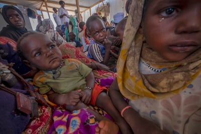 Sudanese refugees sit in a makeshift tent in the Adre transit camp in Chad. EPA