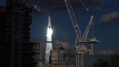 The sun reflects off the windows of the Shard skyscraper as construction cranes stand above building works at the Elephant & Castle Regeneration site. Middle Eastern SWFs, known for buying large trophy buildings in London and other key European cities, signed deals to buy US$6.5 billion worth of property in the first nine months of this year. Simon Dawson / Bloomberg