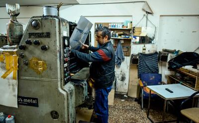 A technician installs the print plate for a page of the Afrika Gazetesi newspaper's forthcoming edition at its print house in the northern side of the Cypriot capital Nicosia. AFP