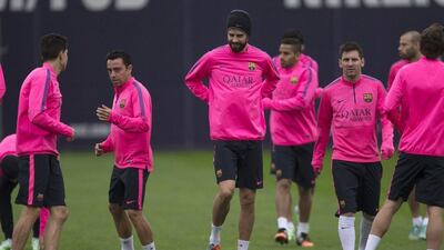 Barcelona players Marc Bartra, left, Xavi, second left, Gerard Pique, centre, and Lionel Messi, right, shown during a team training session on Saturday. Alejandro Garcia / EPA / November 29, 2014