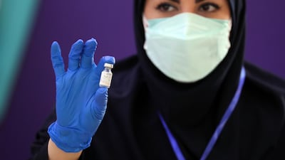 An Iranian health worker holds up a dose of the locally-made CovIran Barekat vaccine, in the capital Tehran. EPA-EFE