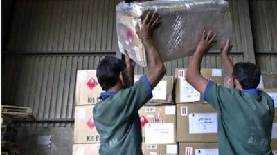 Airport staff in the UAE prepare cargo for shipment to Iraq. Operators say the high fees to fly cargo into Iraq are unfeasible.