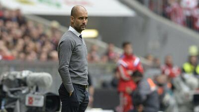 Bayern Munich's Pep Guardiola observes his side during their Bundesliga loss to Augsburg on Saturday. Christof Stache / AFP / May 9, 2015