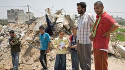 Surviving members of the Samuni family stand by the ruins of their home.