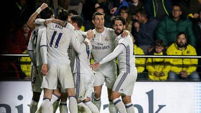 Real Madrid players celebrate. Biel Alino / AFP