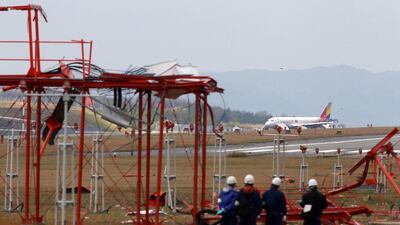 Officials check broken localiser facilities at the Hiroshima airport. Jiji Press / AFP Photo