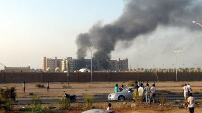 People gather near the Al-Qasr Hotel after it was attacked. Stringer / EPA