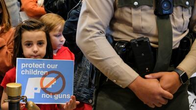 A child holds a sign inside the Tennessee State Capitol during a protest to end gun violence and support stronger gun laws after a deadly shooting at the Covenant School in Nashville. Reuters