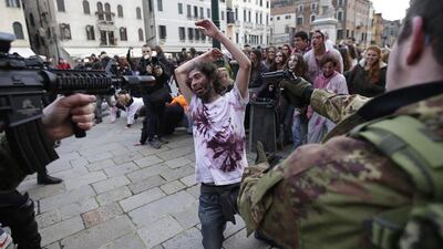 Participants dressed as zombies and soldiers simulate a fight during a “Zombie Walk.” Max Rossi / Reuters