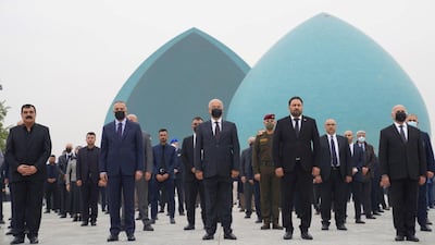 Iraq's President Barham Salih and Prime Minister Mustafa Al Kadhimi attend a funeral ceremony in Baghdad on February 4, 2021 for 104 members of the minority Yazidi sect who were killed by ISIS militants in 2014. The Presidency of the Republic of Iraq Office via Reuters